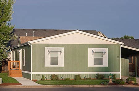 Large manufactured home with carport.